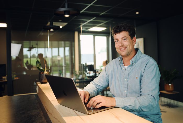 Professional working at a laptop at a desk.